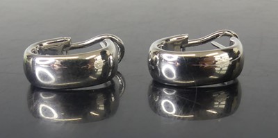 Lot 2553 - A pair of 18ct white gold half-hoop earrings,...