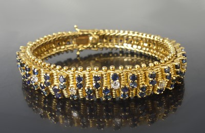 Lot 2512 - A yellow metal, sapphire and diamond two-row...