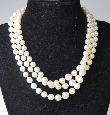 Lot 2514 - A three-row cultured Akoya pearl necklace,...