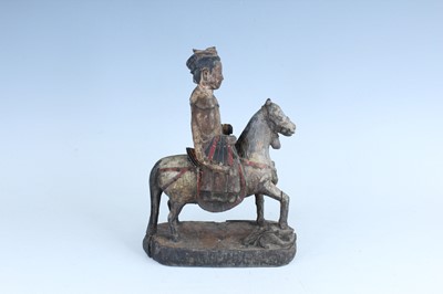 Lot 45 - A Chinese painted wooden figure of a rider on...