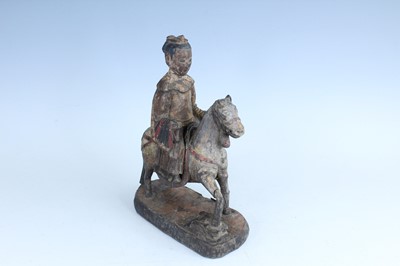 Lot 45 - A Chinese painted wooden figure of a rider on...
