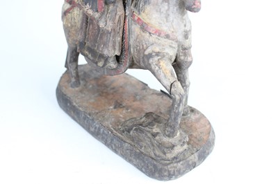 Lot 45 - A Chinese painted wooden figure of a rider on...