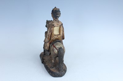 Lot 45 - A Chinese painted wooden figure of a rider on...