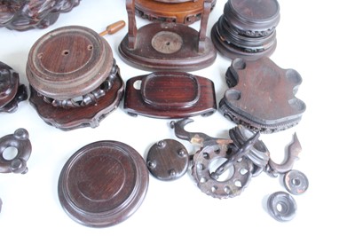 Lot 46 - A collection of Chinese wooden stands and...