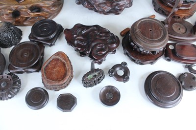 Lot 46 - A collection of Chinese wooden stands and...