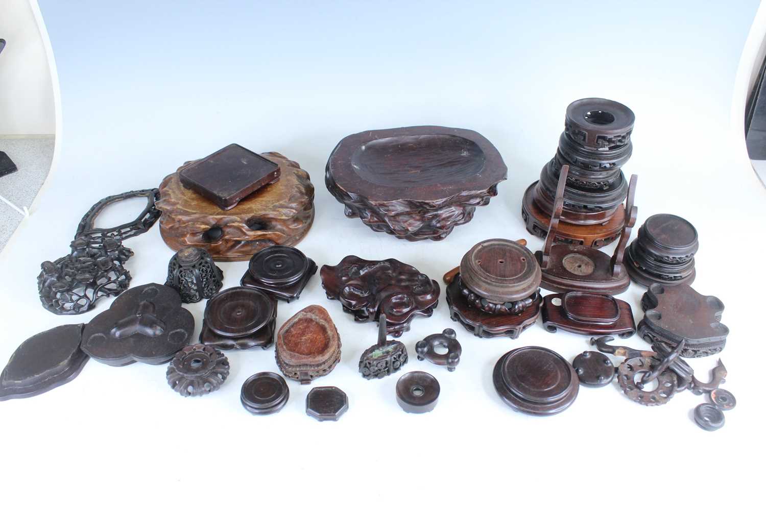 Lot 46 - A collection of Chinese wooden stands and...