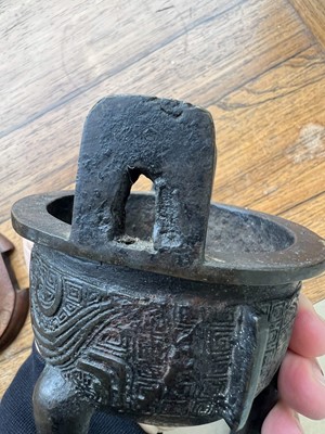 Lot 69 - Two Chinese bronze tripod censers, Qing...