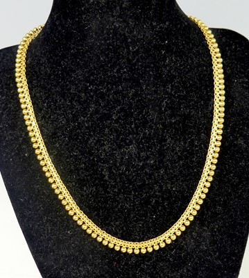 Lot 2573 - A middle-eastern yellow metal fringe necklace,...