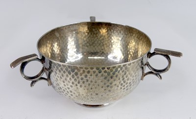 Lot 110 - An Art Deco hammered silver triple-handled...