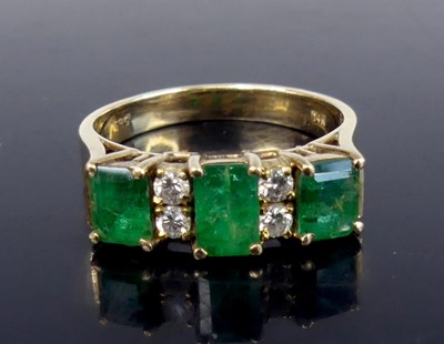 Lot 2561 - A yellow metal, emerald and diamond half-hoop...