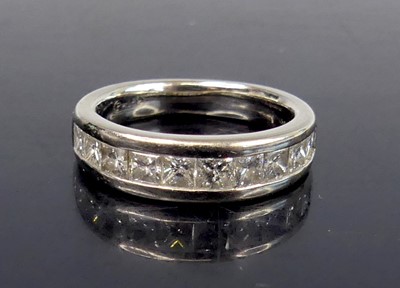 Lot 2589 - An 18ct white gold diamond half-hoop ring,...