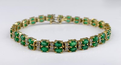 Lot 2569 - A yellow metal, emerald and diamond line...
