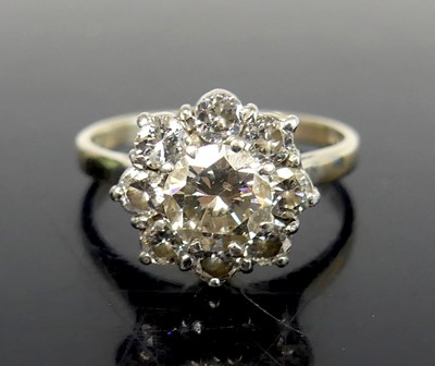 Lot 2583 - An 18ct white gold diamond circular cluster...