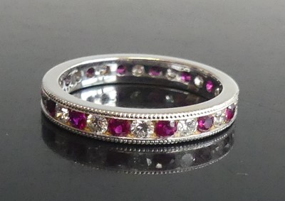 Lot 2594 - A white metal, ruby and diamond eternity ring,...
