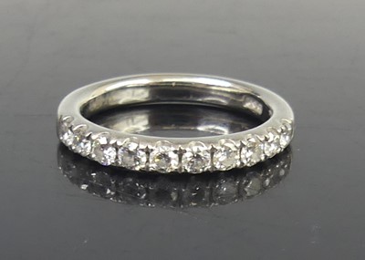 Lot 2729 - A platinum diamond half-hoop ring, comprising...