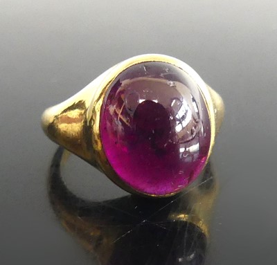 Lot 2599 - A yellow metal garnet signet ring, having an...