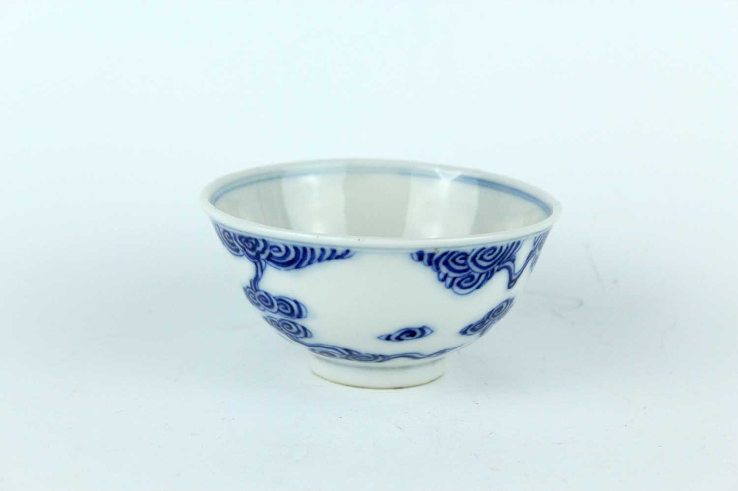 Lot 7 - A small Chinese blue and white ‘swirling...