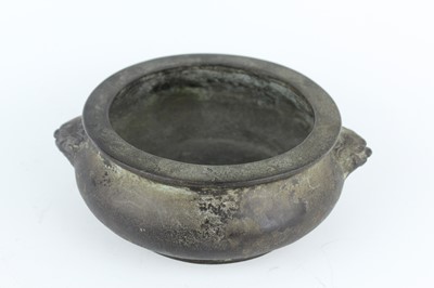 Lot 74 - A Chinese bronze censer with two mask handles,...
