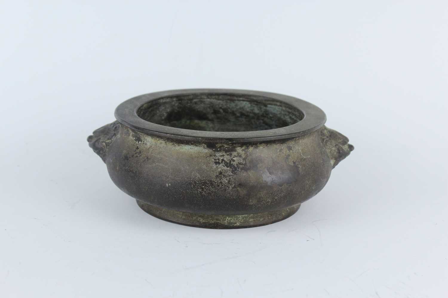 Lot 74 - A Chinese bronze censer with two mask handles,...