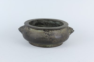 Lot 74 - A Chinese bronze censer with two mask handles,...