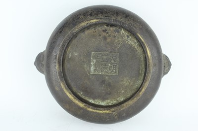 Lot 74 - A Chinese bronze censer with two mask handles,...