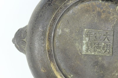 Lot 74 - A Chinese bronze censer with two mask handles,...