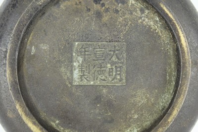 Lot 74 - A Chinese bronze censer with two mask handles,...