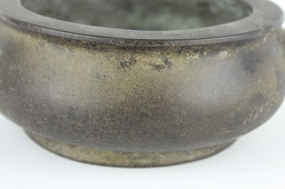 Lot 74 - A Chinese bronze censer with two mask handles,...
