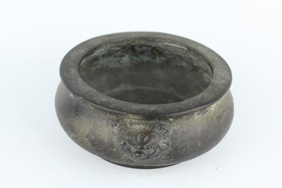 Lot 74 - A Chinese bronze censer with two mask handles,...