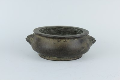 Lot 74 - A Chinese bronze censer with two mask handles,...