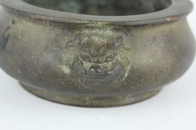Lot 74 - A Chinese bronze censer with two mask handles,...