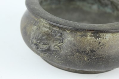 Lot 74 - A Chinese bronze censer with two mask handles,...