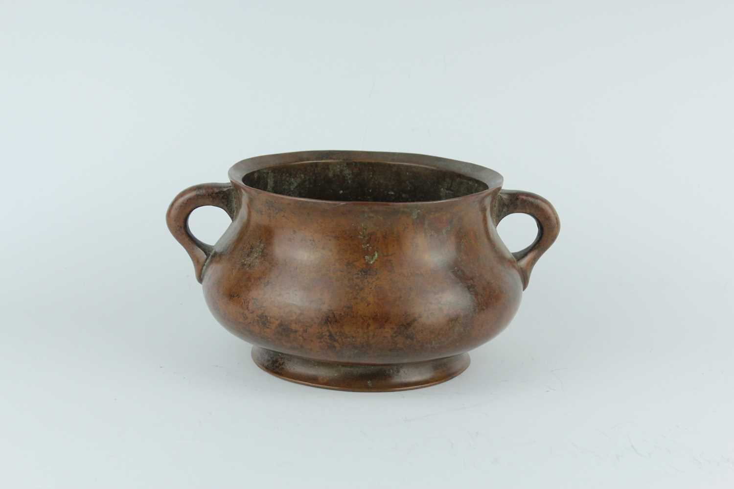 Lot 73 - A Chinese bronze censer with two loop handles,...