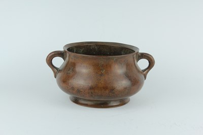 Lot 73 - A Chinese bronze censer with two loop handles,...