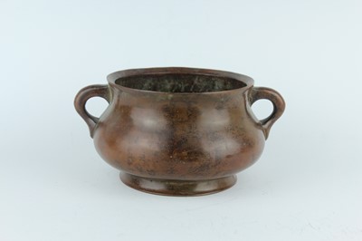 Lot 73 - A Chinese bronze censer with two loop handles,...