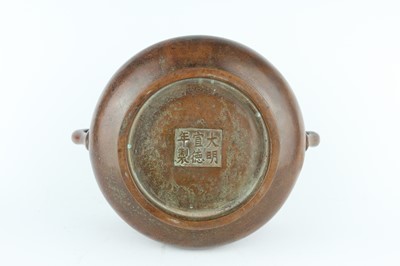 Lot 73 - A Chinese bronze censer with two loop handles,...