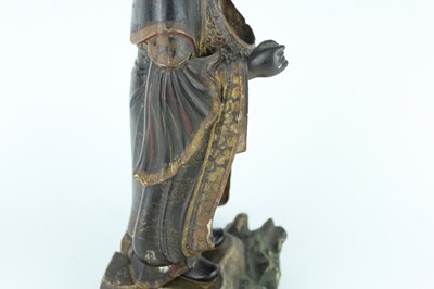 Lot 44 - A Chinese lacquered wooden figure of a deity,...