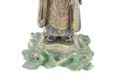 Lot 44 - A Chinese lacquered wooden figure of a deity,...
