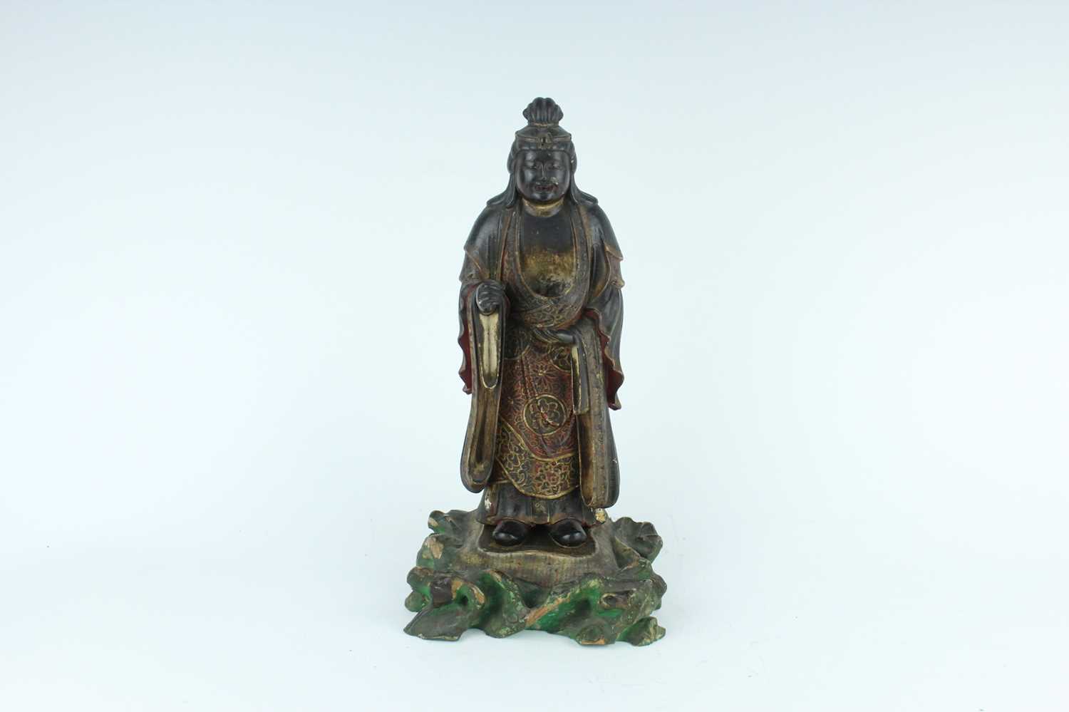 Lot 44 - A Chinese lacquered wooden figure of a deity,...