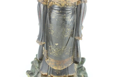 Lot 44 - A Chinese lacquered wooden figure of a deity,...