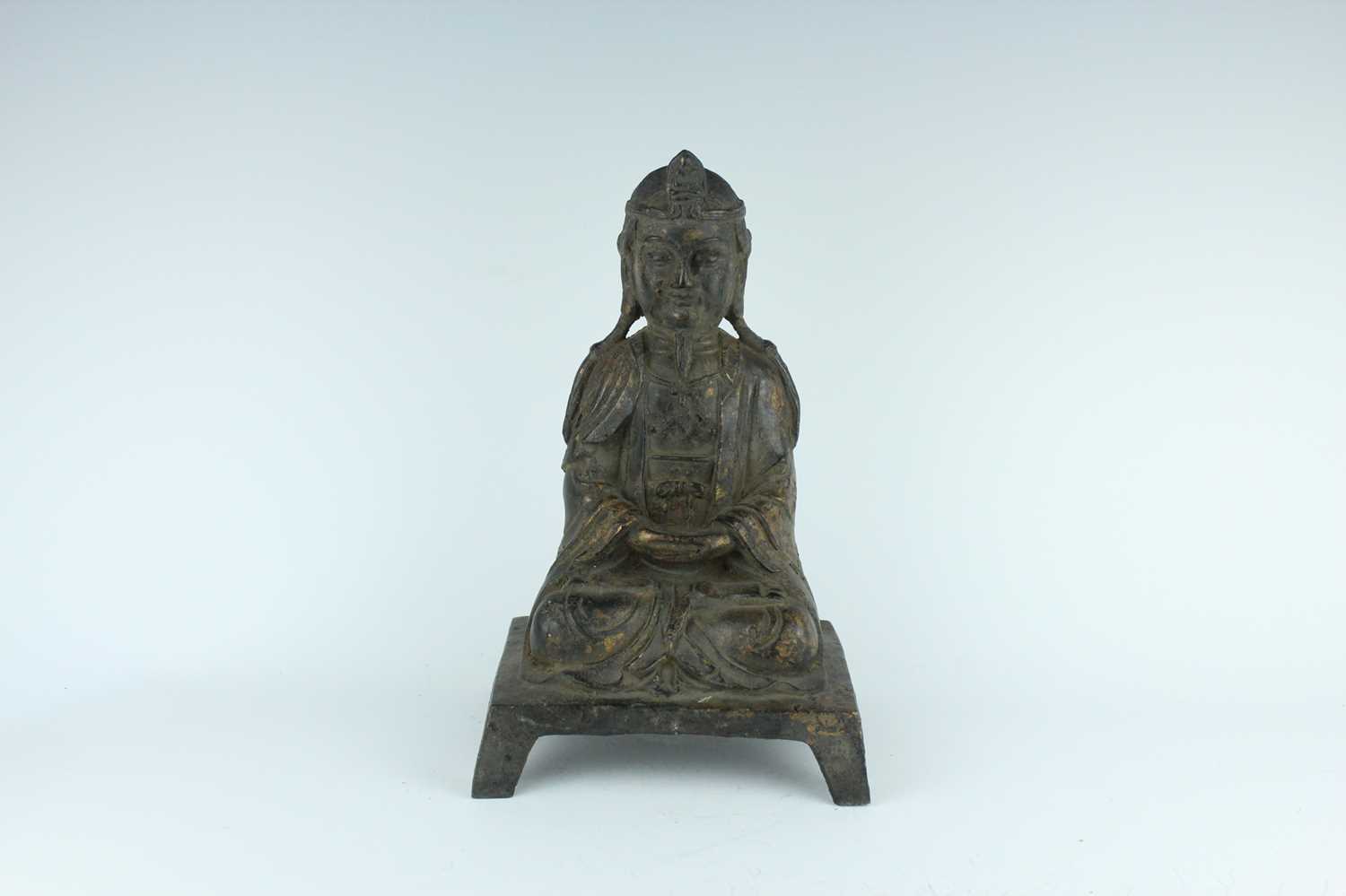 Lot 65 - A Chinese bronze figure of a seated...