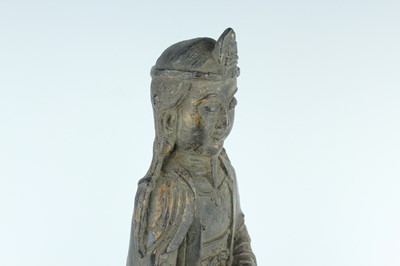 Lot 65 - A Chinese bronze figure of a seated...