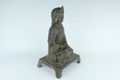 Lot 65 - A Chinese bronze figure of a seated...