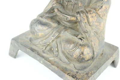 Lot 65 - A Chinese bronze figure of a seated...