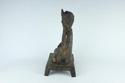 Lot 65 - A Chinese bronze figure of a seated...