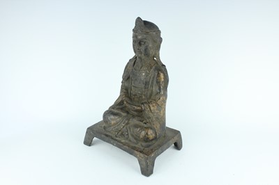 Lot 65 - A Chinese bronze figure of a seated...