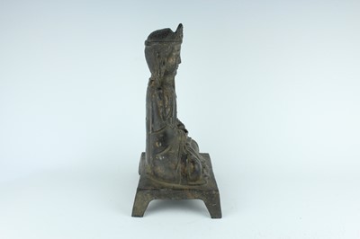 Lot 65 - A Chinese bronze figure of a seated...