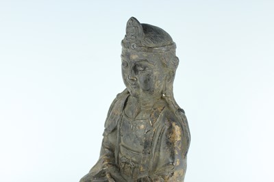 Lot 65 - A Chinese bronze figure of a seated...