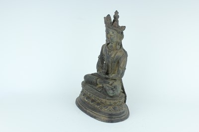 Lot 67 - A Chinese bronze figure of Buddha seated on a...