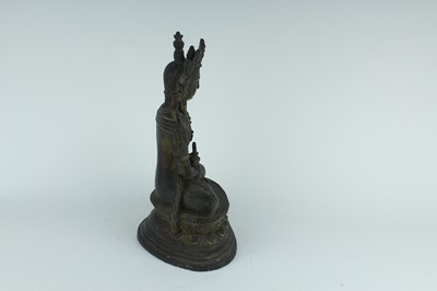 Lot 67 - A Chinese bronze figure of Buddha seated on a...